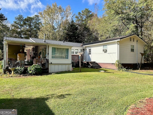 rear view of property with a lawn