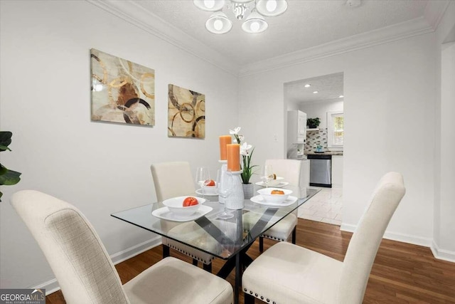 3018 Wanda Cir SW, Atlanta, GA 30315 - dining space featuring a chandelier, ornamental molding, wood finished floors, and baseboards