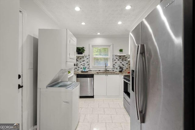 3018 Wanda Cir SW, Atlanta, GA 30315 - kitchen featuring appliances with stainless steel finishes, estacked washer and dryer, open shelves, a sink, and a textured ceiling
