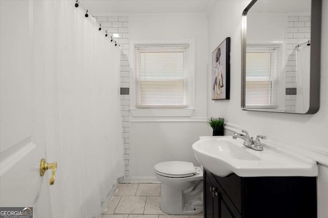 bathroom featuring tile patterned floors, toilet, curtained shower, ornamental molding, and vanity