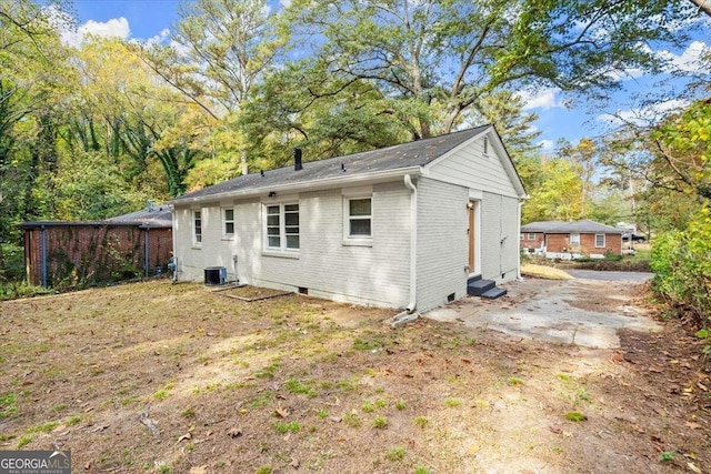 rear view of property with cooling unit