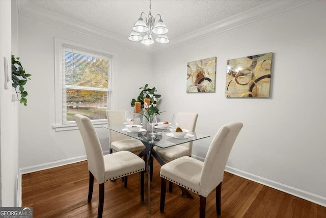 dining area featuring ornamental molding, dark hardwood / wood-style flooring, a notable chandelier, and a textured ceiling