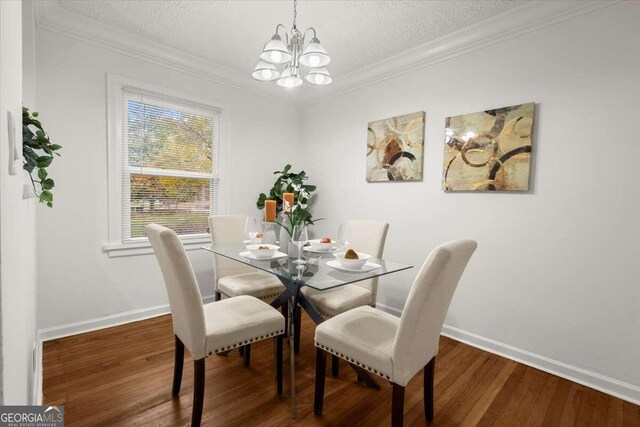3018 Wanda Cir SW, Atlanta, GA 30315 - dining room with a chandelier, a textured ceiling, wood finished floors, baseboards, and ornamental molding