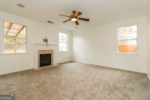 unfurnished living room featuring carpet flooring and ceiling fan