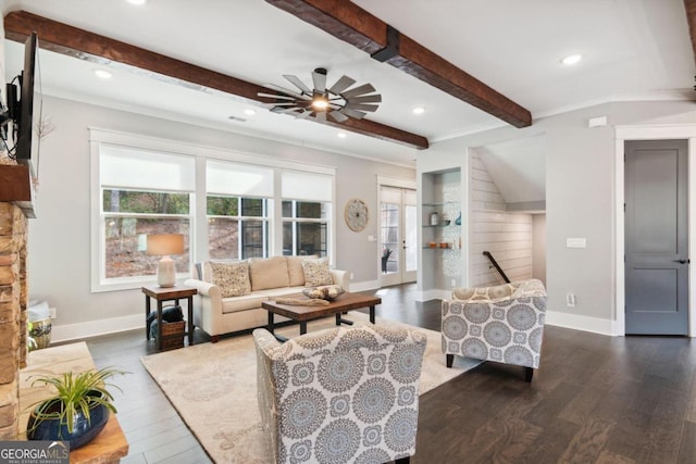 living room with beamed ceiling, ceiling fan, dark hardwood / wood-style floors, and crown molding