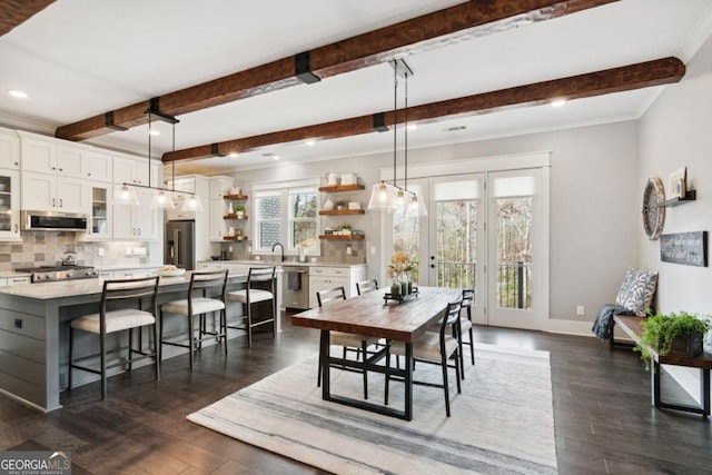 dining space featuring dark hardwood / wood-style flooring, beamed ceiling, and crown molding