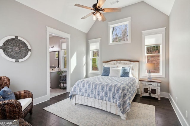 bedroom featuring ensuite bath, ceiling fan, dark hardwood / wood-style floors, and vaulted ceiling