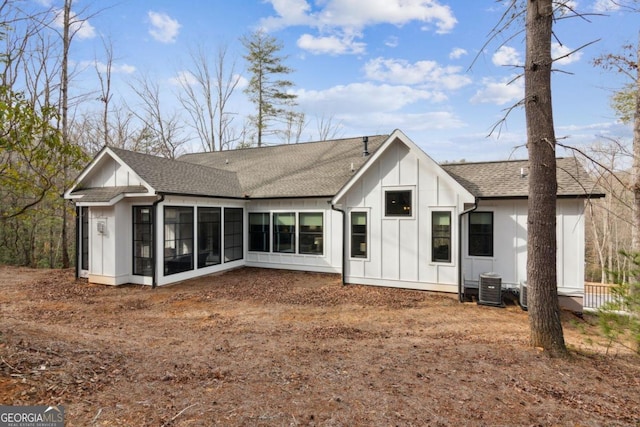 back of house with a sunroom and central AC