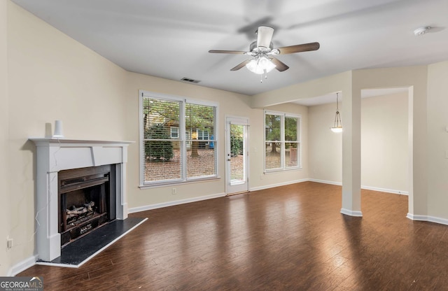 unfurnished living room featuring dark hardwood / wood-style flooring and ceiling fan