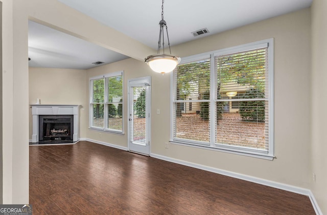 unfurnished living room featuring dark wood-type flooring