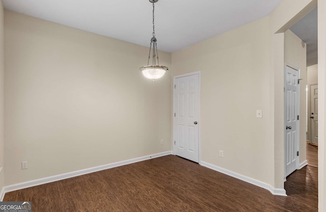 unfurnished room featuring dark wood-type flooring