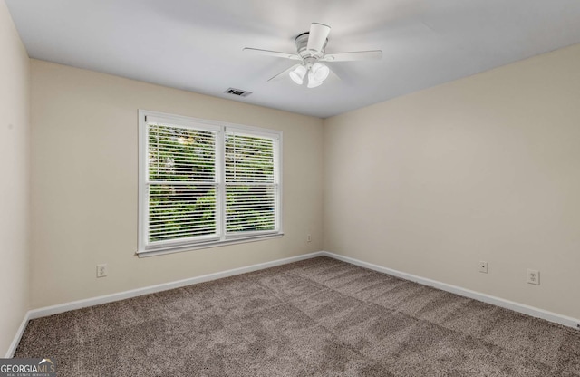 carpeted empty room featuring ceiling fan