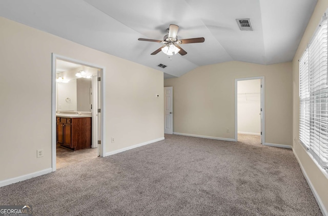 unfurnished bedroom featuring ceiling fan, multiple windows, a closet, and a spacious closet