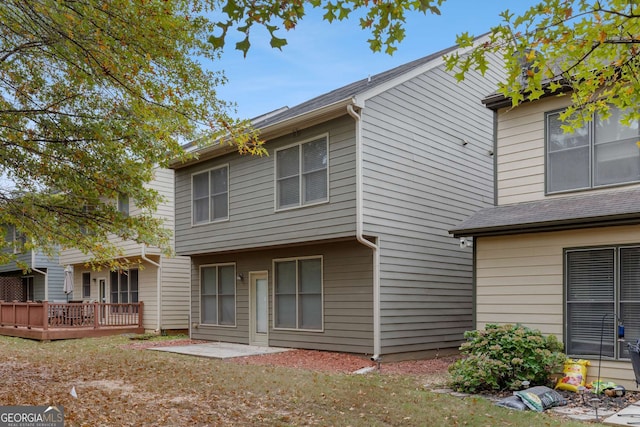 rear view of property featuring a deck