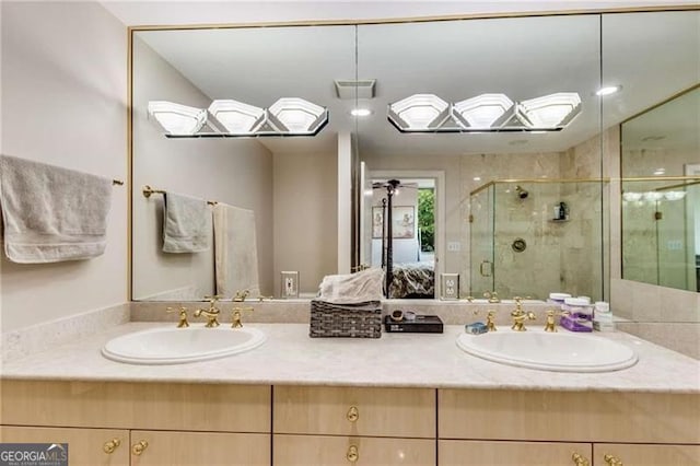 bathroom featuring ceiling fan, vanity, and an enclosed shower