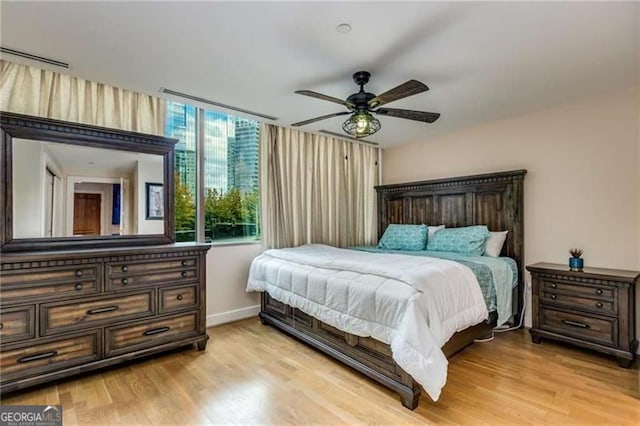 bedroom featuring light hardwood / wood-style flooring and ceiling fan