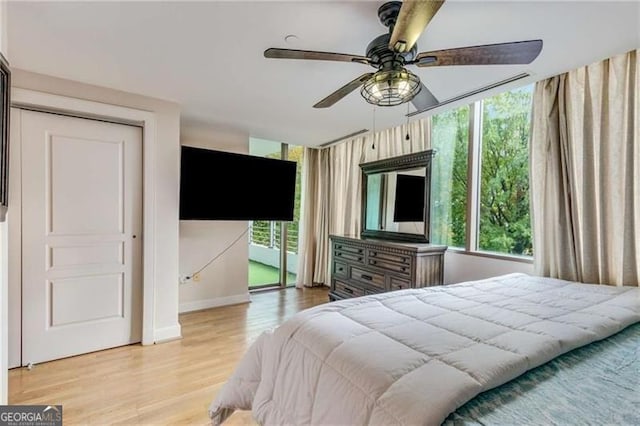 bedroom with light hardwood / wood-style floors and ceiling fan