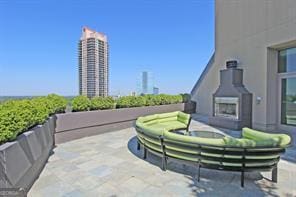 view of patio featuring an outdoor living space with a fireplace