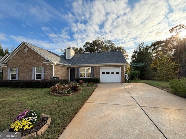 view of front of home with a garage and a front lawn