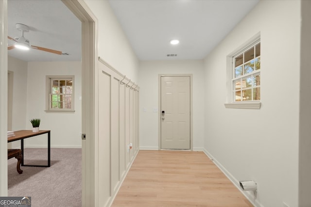 hall with light hardwood / wood-style flooring