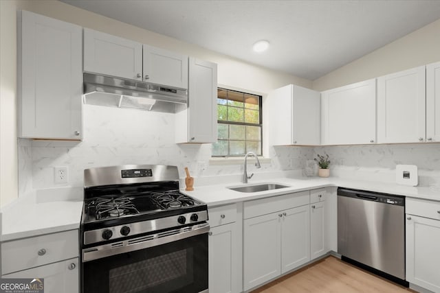 kitchen with sink, white cabinets, and stainless steel appliances