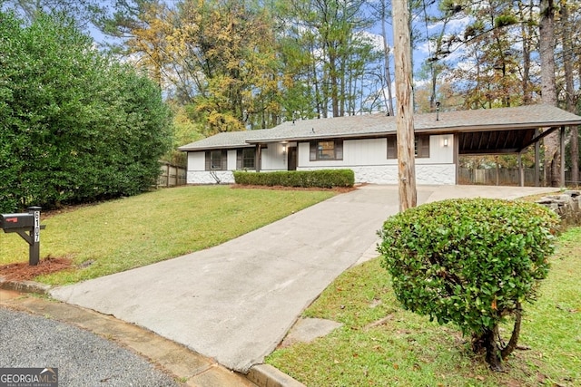 single story home with a front yard and a carport