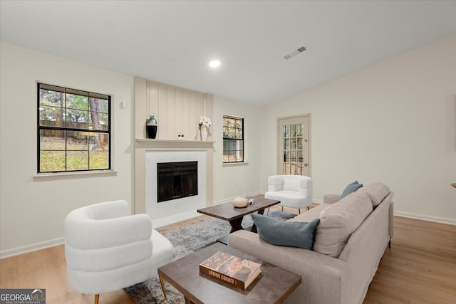 living room with lofted ceiling and light hardwood / wood-style flooring