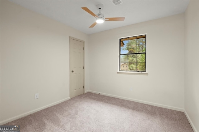 empty room with ceiling fan and carpet floors