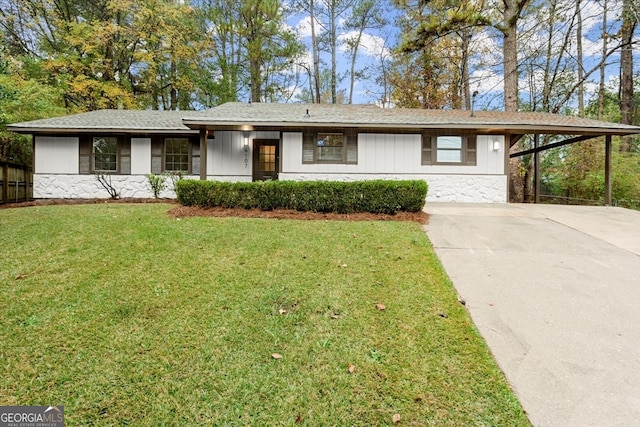 ranch-style house with a front yard and a carport