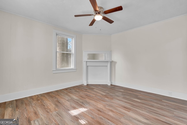 unfurnished living room with light wood-type flooring, ceiling fan, and crown molding