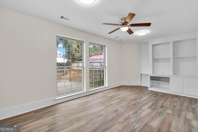 unfurnished living room with ceiling fan and light wood-type flooring