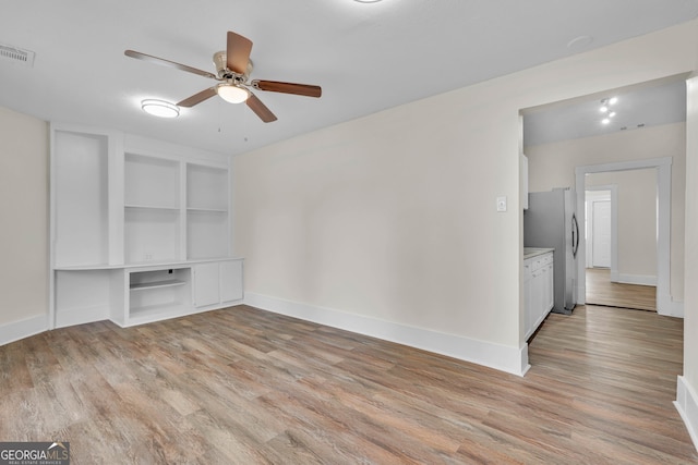 interior space with light wood-type flooring and ceiling fan