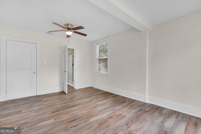 empty room featuring hardwood / wood-style flooring and ceiling fan