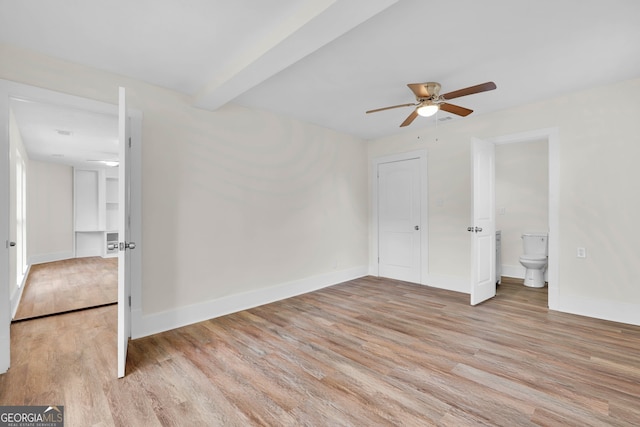 unfurnished bedroom featuring ensuite bathroom, ceiling fan, and light hardwood / wood-style flooring