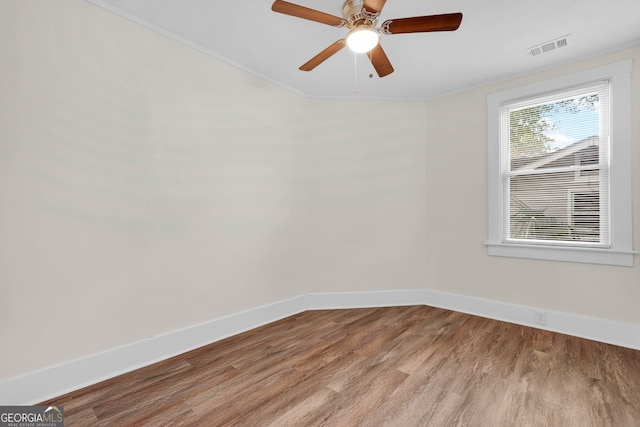 spare room with ornamental molding, light hardwood / wood-style flooring, and ceiling fan