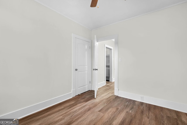 empty room featuring ceiling fan and wood-type flooring