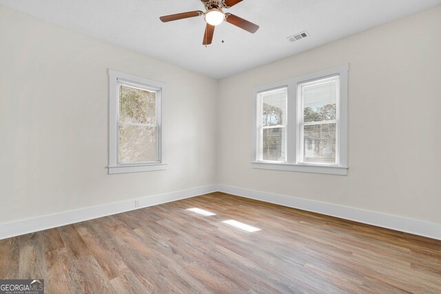 unfurnished room featuring light wood-type flooring and ceiling fan