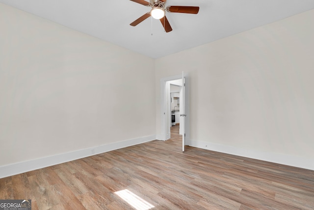 spare room with light hardwood / wood-style floors and ceiling fan