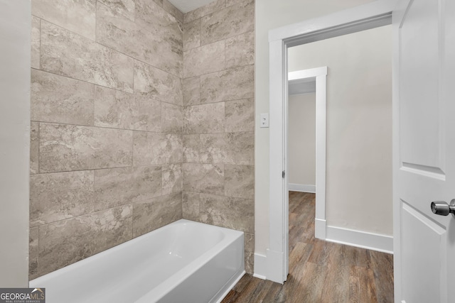 bathroom featuring tiled shower / bath combo and hardwood / wood-style floors