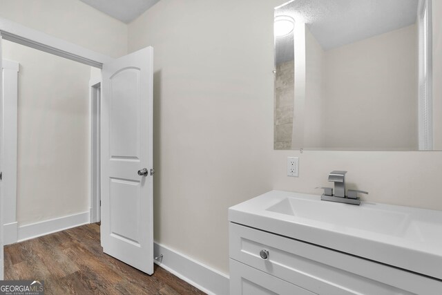 bathroom featuring vanity and hardwood / wood-style floors