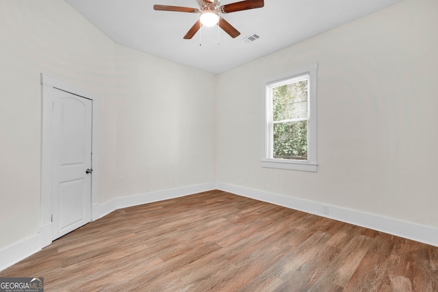 empty room with ceiling fan and light hardwood / wood-style flooring