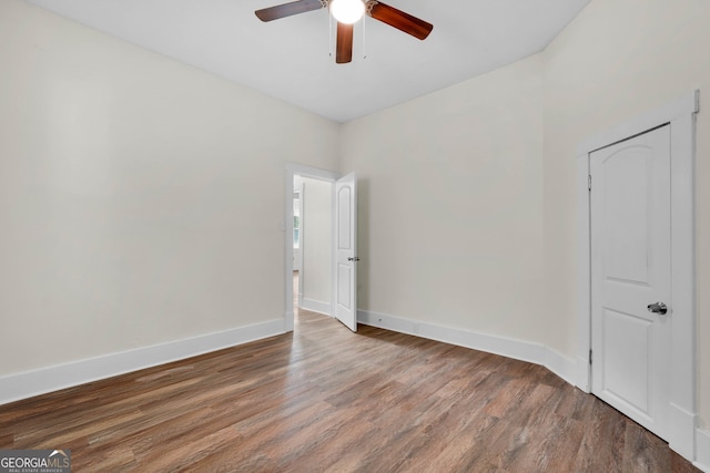 empty room with hardwood / wood-style floors and ceiling fan