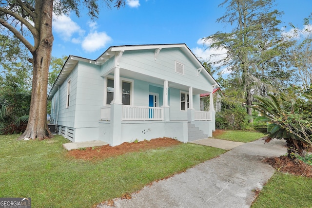 bungalow-style house featuring a front yard and covered porch