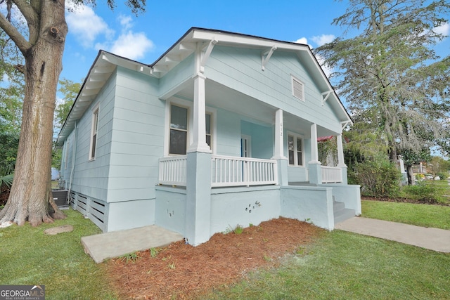 bungalow-style house with covered porch and a front lawn