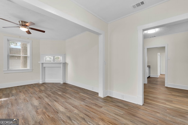 unfurnished living room with ceiling fan, wood-type flooring, and ornamental molding