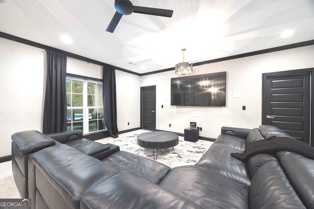 home theater featuring ornamental molding, light carpet, and ceiling fan