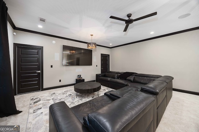 cinema room featuring ornamental molding, light carpet, and ceiling fan