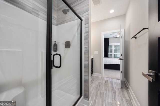 bathroom with ceiling fan and a shower with shower door