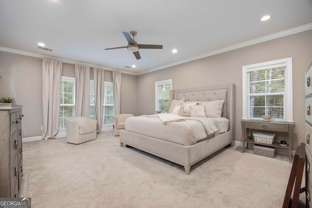 bedroom with ornamental molding, light colored carpet, and ceiling fan