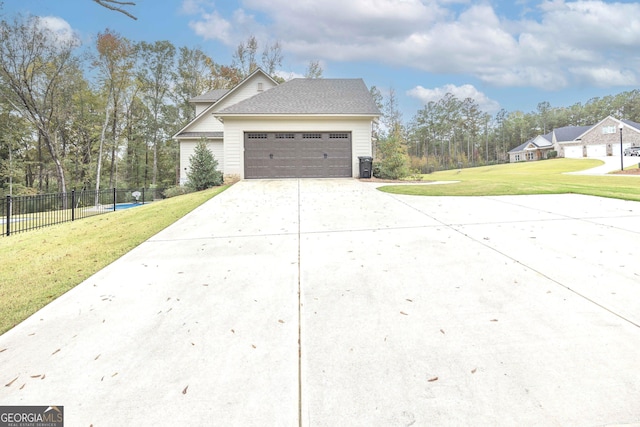 view of side of home with a garage and a lawn